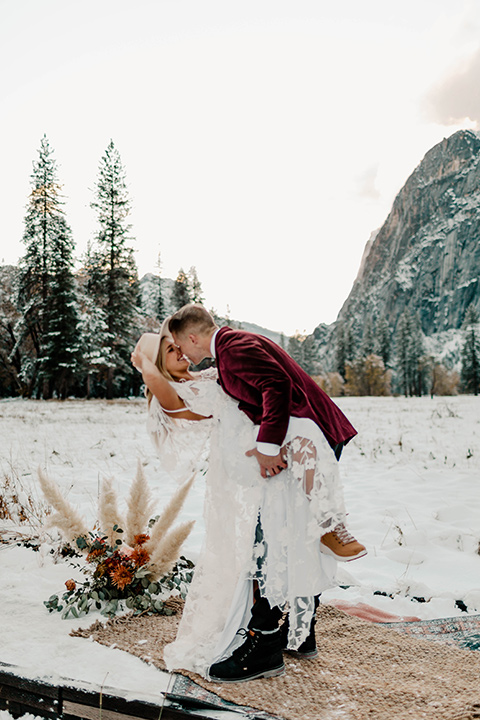  winter Yosemite wedding with the groom in a burgundy velvet tuxedo 