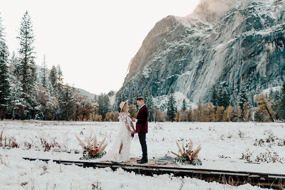  winter Yosemite wedding with the groom in a burgundy velvet tuxedo
