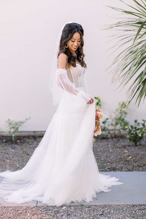  70s inspired wedding with orange and caramel tones with the bride in a lace gown and the groom in a caramel suit - bride 