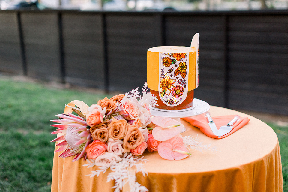  70s inspired wedding with orange and caramel tones with the bride in a lace gown and the groom in a caramel suit - cake