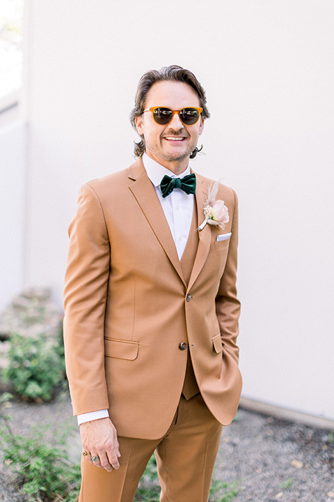  70s inspired wedding with orange and caramel tones with the bride in a lace gown and the groom in a caramel suit - groom 