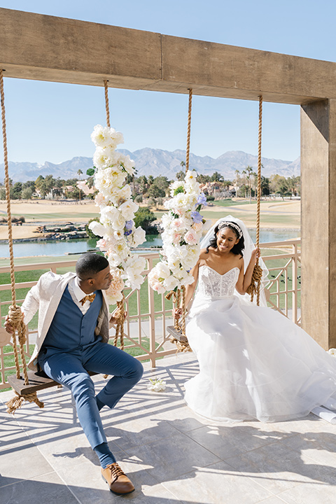  a Bridgerton inspired garden wedding in Las Vegas - couple on swings 