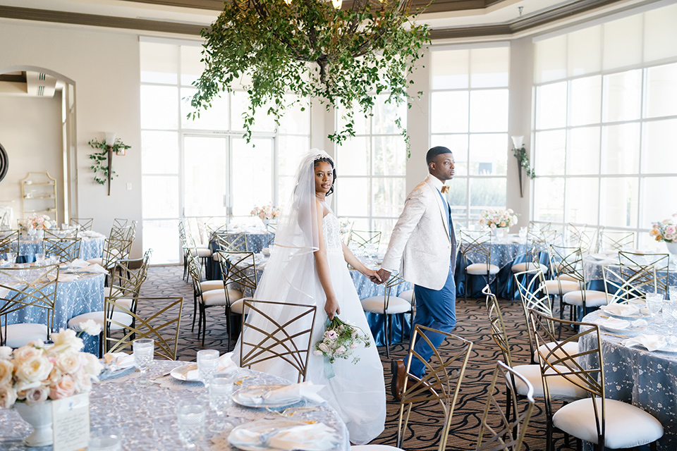  a Bridgerton inspired garden wedding in Las Vegas - couple walking in reception 