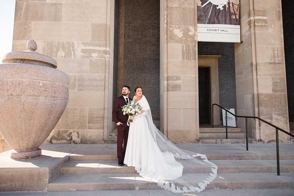  burgundy and green wedding with winter vibes - couple on the steps 