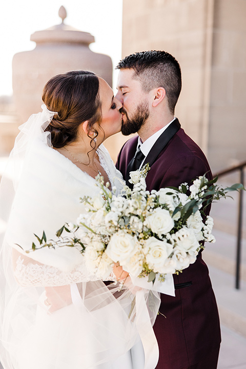  burgundy and green wedding with winter vibes – couple on the steps 