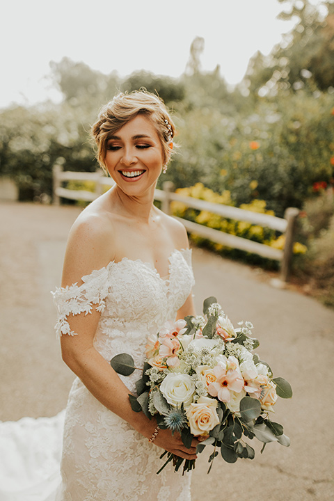  a romantic rustic garden wedding with the groom in a blue suit and floral tie and the bride in a lace gown - bride 