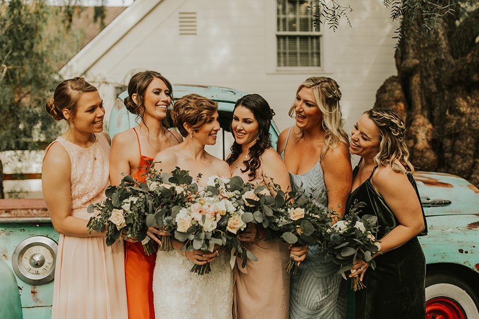  a romantic rustic garden wedding with the groom in a blue suit and floral tie and the bride in a lace gown - bridesmaids