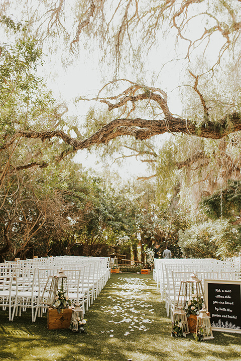  a romantic rustic garden wedding with the groom in a blue suit and floral tie and the bride in a lace gown - ceremony décor 