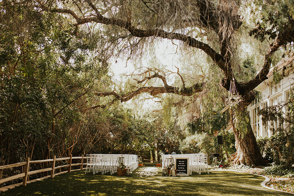  a romantic rustic garden wedding with the groom in a blue suit and floral tie and the bride in a lace gown - ceremony space 