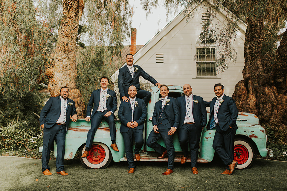  a romantic rustic garden wedding with the groom in a blue suit and floral tie and the bride in a lace gown - groomsmen 