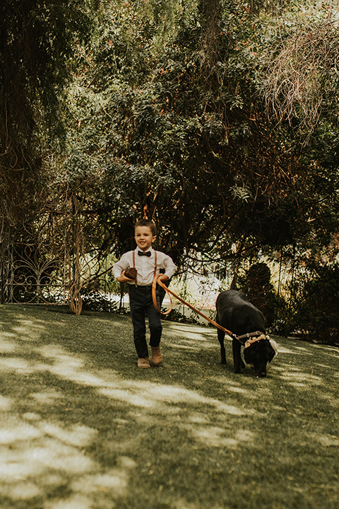  a romantic rustic garden wedding with the groom in a blue suit and floral tie and the bride in a lace gown - ceremony décor 