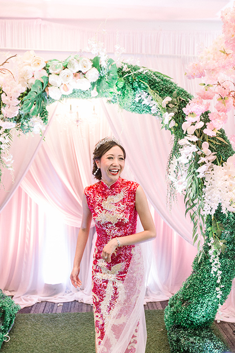  a grand cultural wedding with lion dancers and gold details – bride in a long gown with cape and groom in navy shawl tuxedo – bride in her red gown 