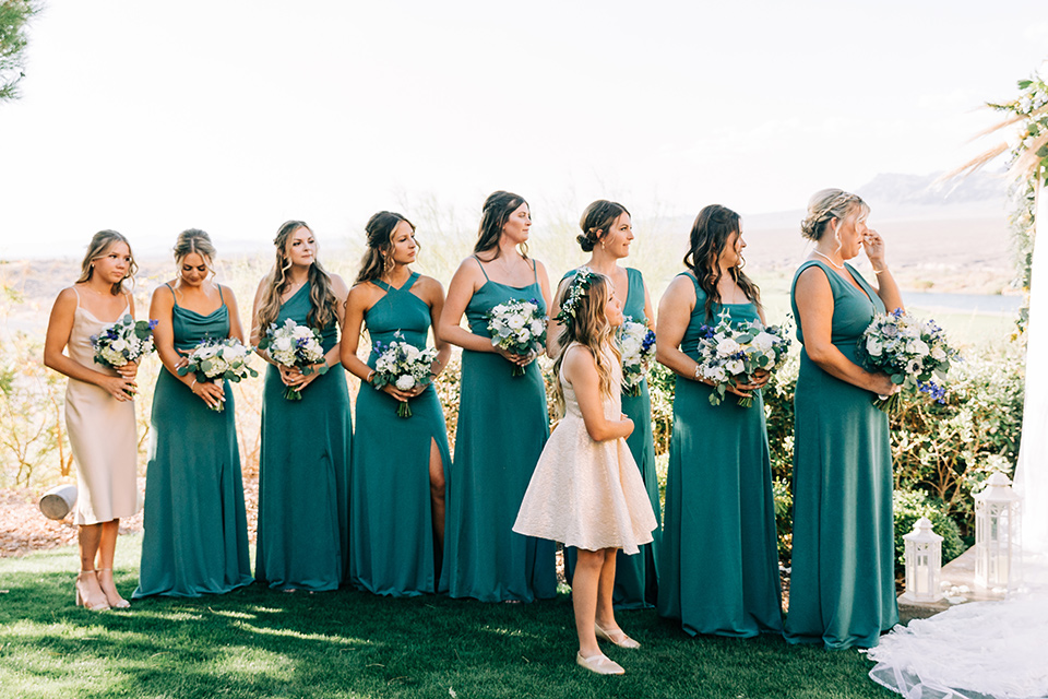  a tan and teal wedding with rustic chic details – bridesmaids at the ceremony 
