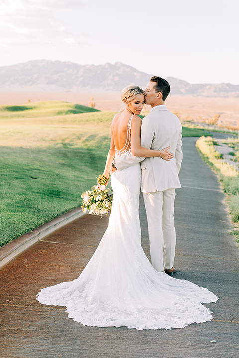  a tan and teal wedding with rustic chic details – couple embracing 