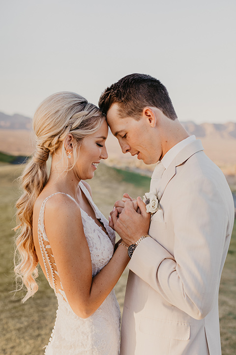  a tan and teal wedding with rustic chic details – couple embracing 