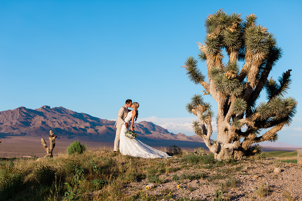  a tan and teal wedding with rustic chic details – groomsmen kissing 