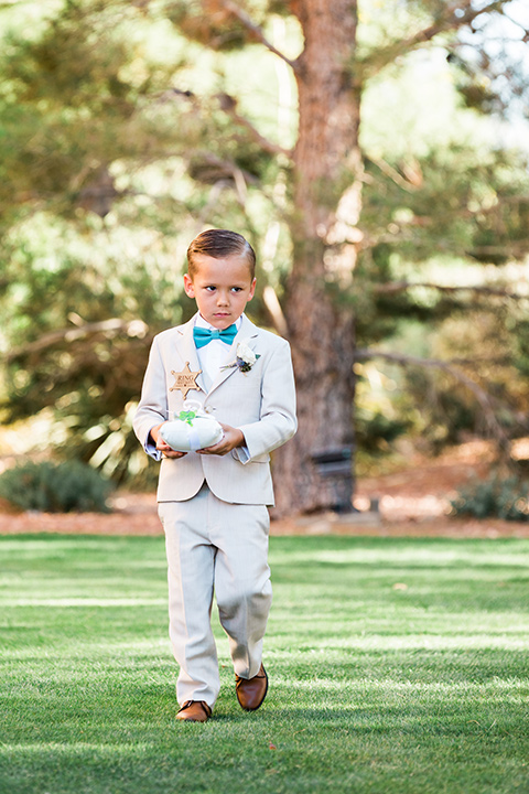  a tan and teal wedding with rustic chic details – ring bearer 