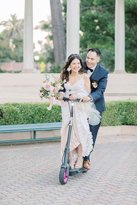  classic and modern balboa wedding with the groom in a navy shawl – couple on scooter