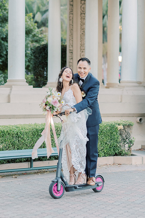  classic and modern balboa wedding with the groom in a navy shawl – couple on scooter 