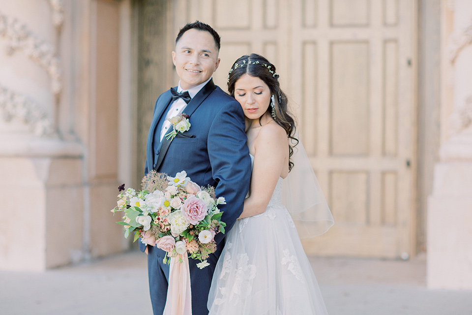  classic and modern balboa wedding with the groom in a navy shawl – couple hugging 