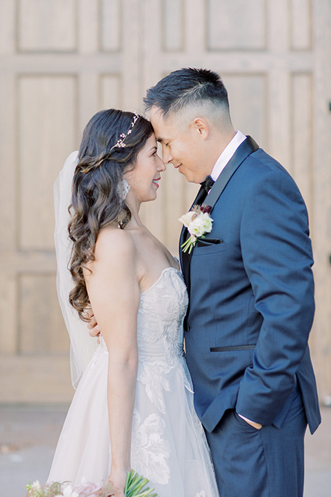  classic and modern balboa wedding with the groom in a navy shawl – couple embracing