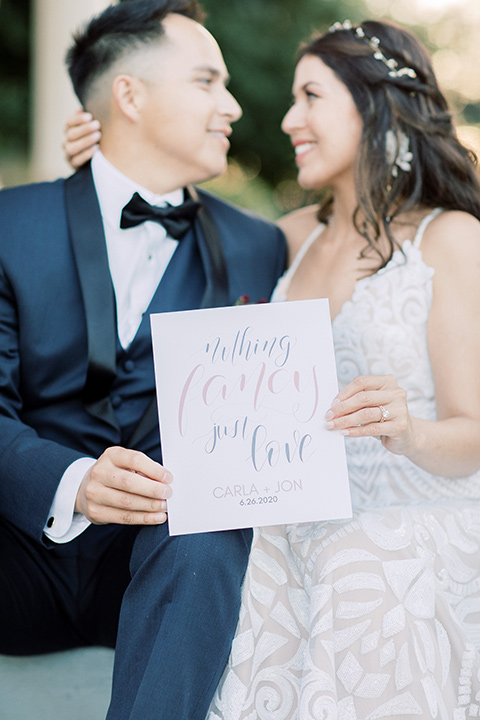  classic and modern balboa wedding with the groom in a navy shawl – couple on steps 