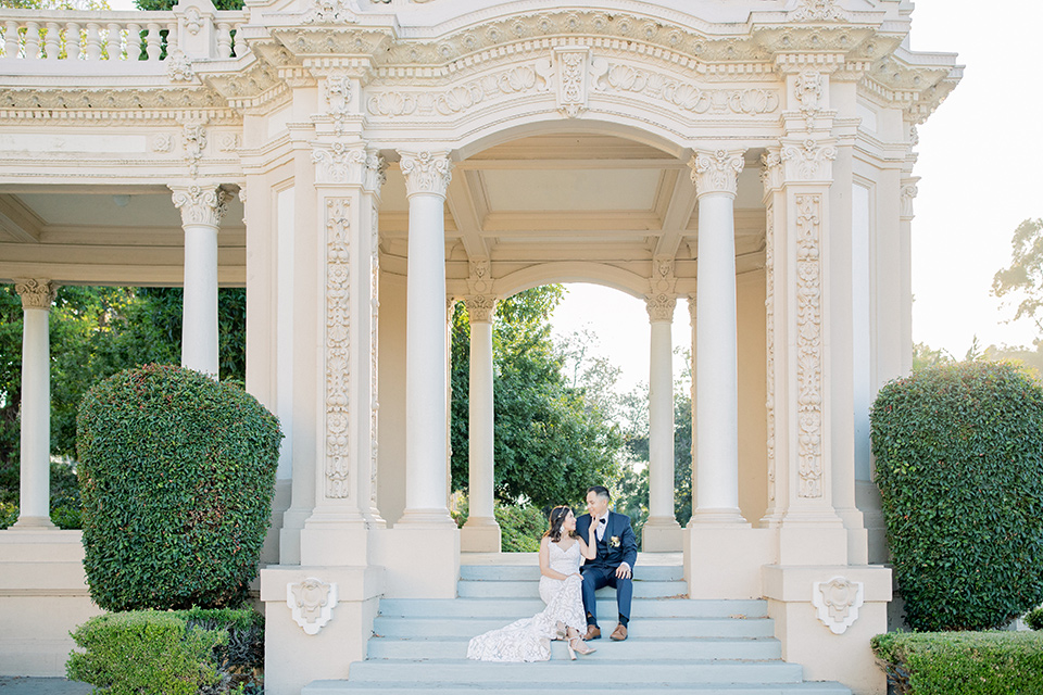  classic and modern balboa wedding with the groom in a navy shawl – couple on steps