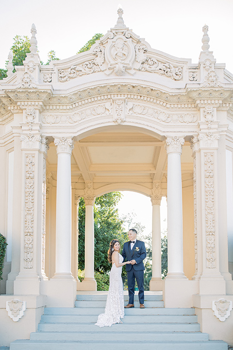  classic and modern balboa wedding with the groom in a navy shawl – couple on steps