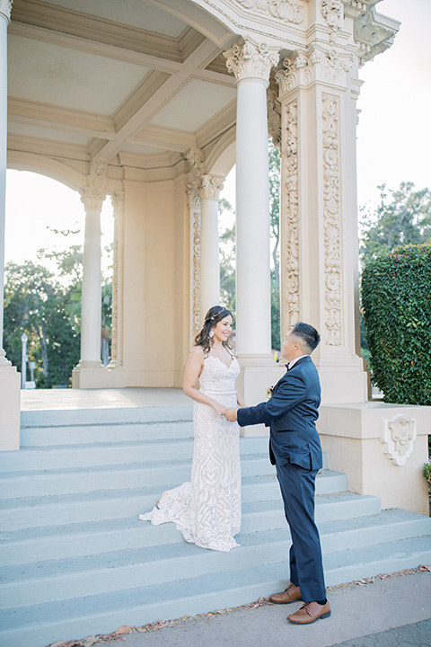  classic and modern balboa wedding with the groom in a navy shawl – couple on steps 