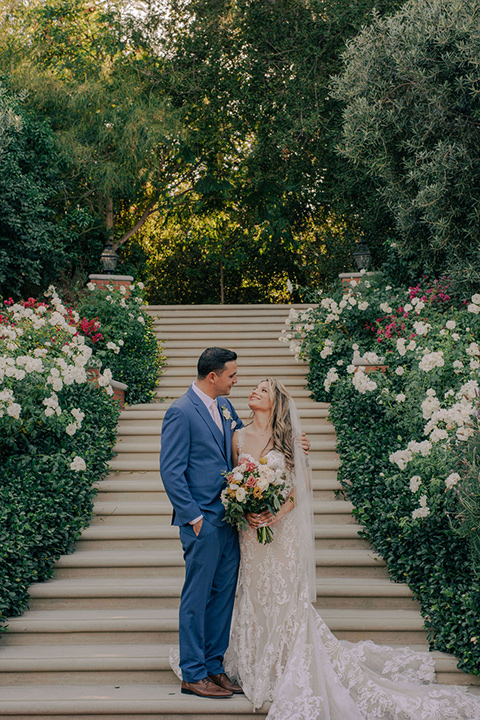  a romantic blush and blue wedding with garden details - couple on stairs 