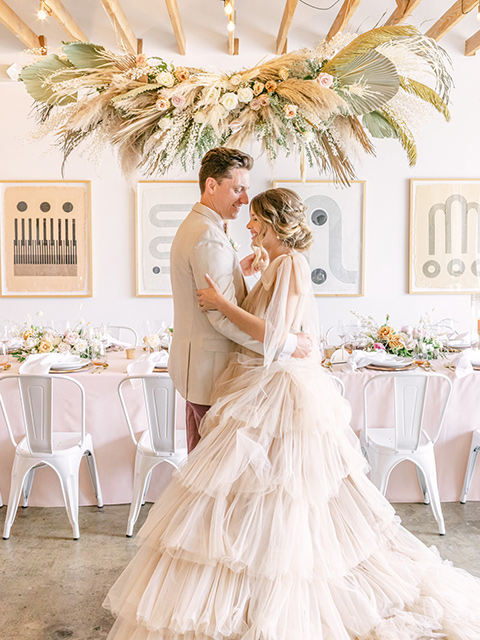  fun pink and champagne wedding with the bride in a pink tulle gown and the groom n a tan and pink look- first dance 