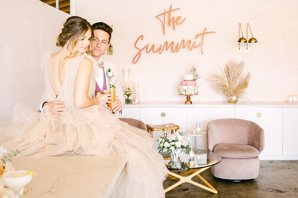  fun pink and champagne wedding with the bride in a pink tulle gown and the groom n a tan and pink look- on the bar