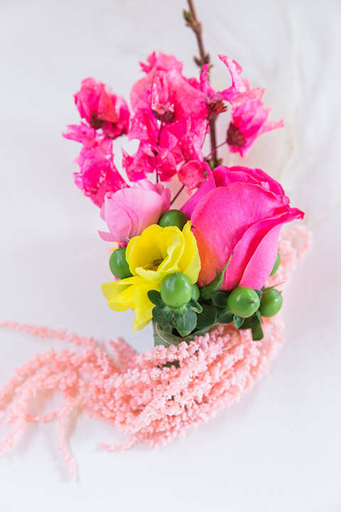  bright and bold lesbian wedding in Palm Springs with one bride in a rose pink suit and the other in a white suit – rings