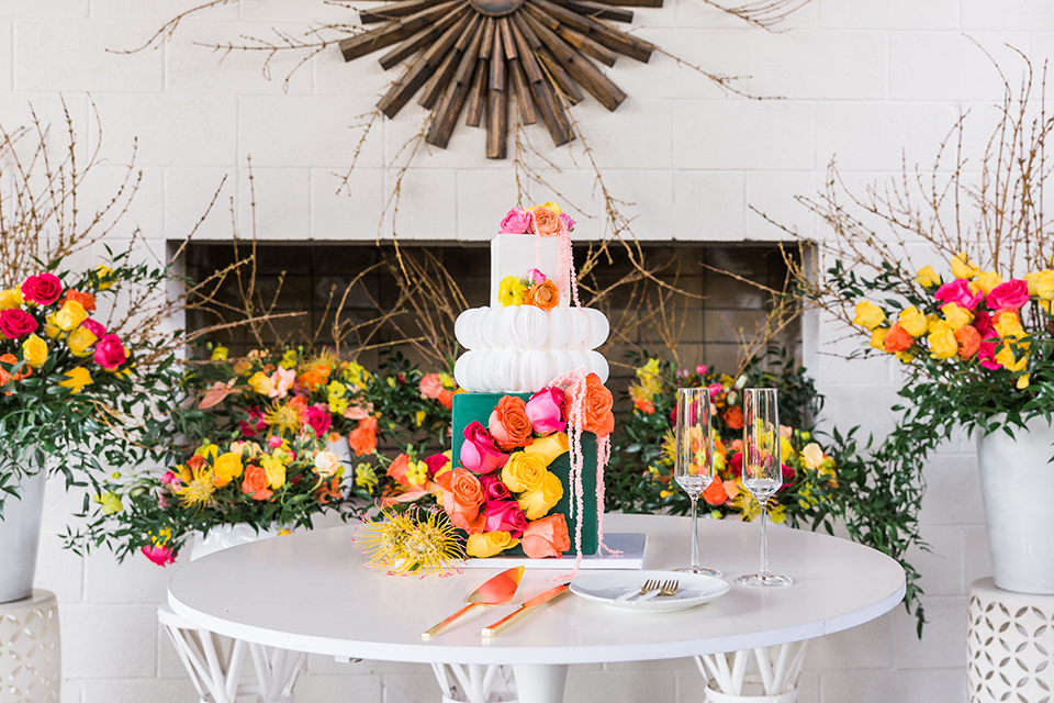  bright and bold lesbian wedding in Palm Springs with one bride in a rose pink suit and the other in a white suit – cake and desserts