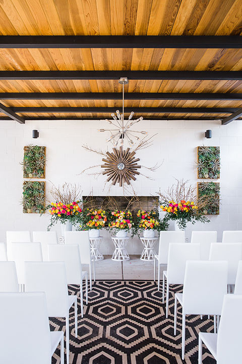  bright and bold lesbian wedding in Palm Springs with one bride in a rose pink suit and the other in a white suit – ceremony decor