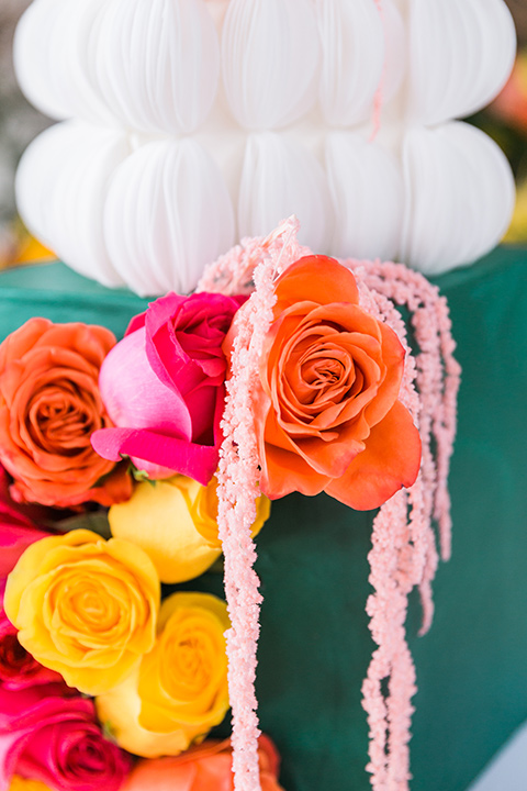  bright and bold lesbian wedding in Palm Springs with one bride in a rose pink suit and the other in a white suit – cake 