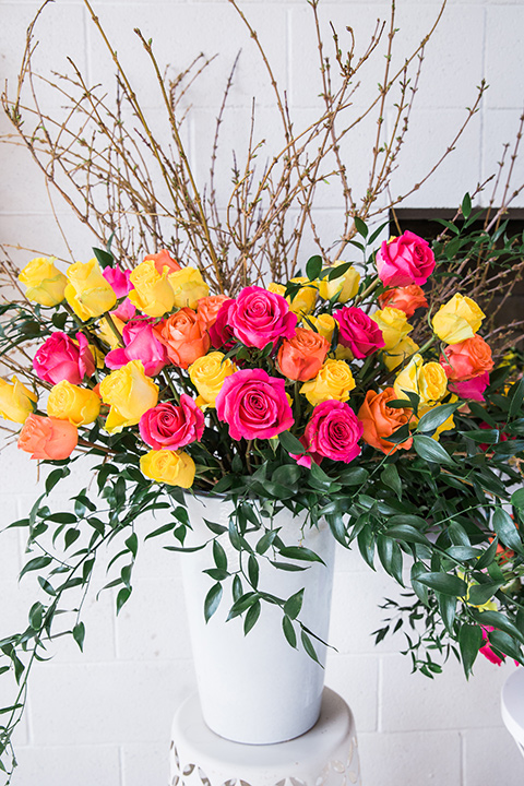  bright and bold lesbian wedding in Palm Springs with one bride in a rose pink suit and the other in a white suit – ceremony flowers 