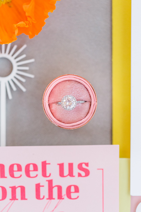  bright and bold lesbian wedding in Palm Springs with one bride in a rose pink suit and the other in a white suit – boutonnière