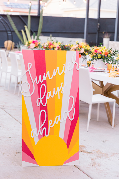  bright and bold lesbian wedding in Palm Springs with one bride in a rose pink suit and the other in a white suit – walking down the aisle