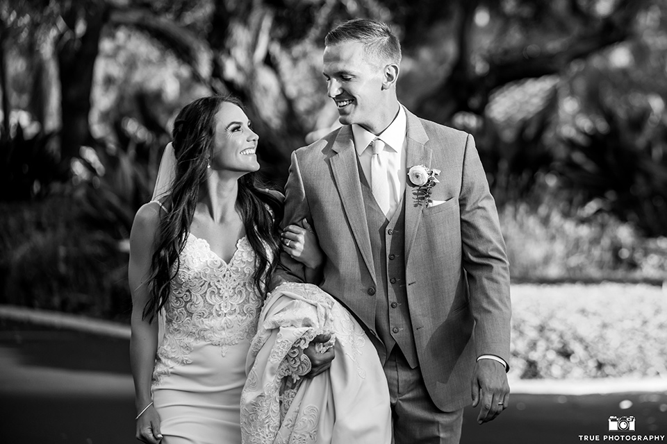  something blue inspired wedding with the bridesmaids in blue dresses the groomsmen in light blue suits and the bride in a lace gown – couple smiling