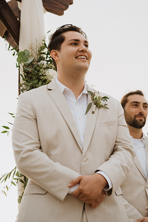  boho modern beach wedding on the sand – groom waiting at ceremony 