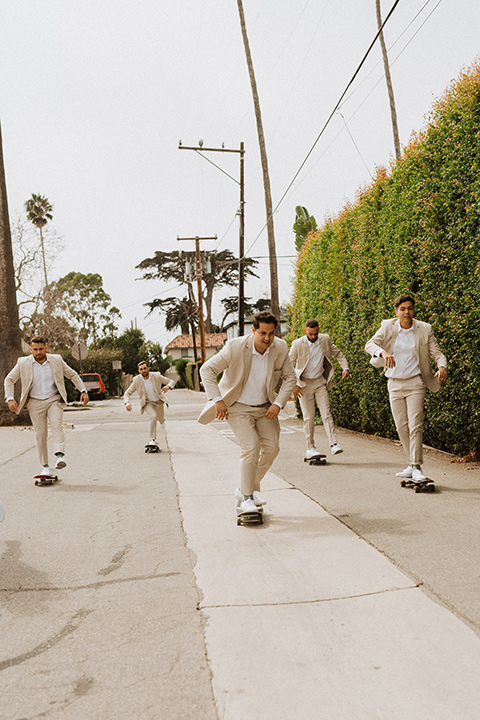  boho modern beach wedding on the sand – groomsmen skating