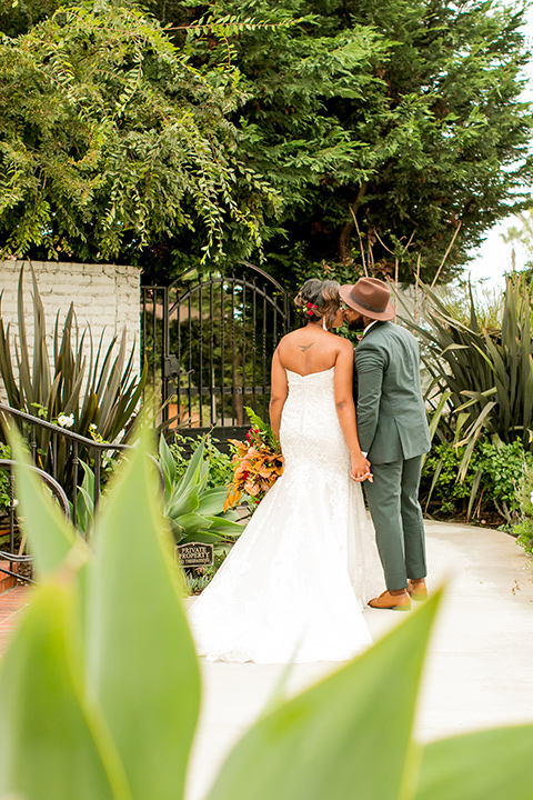 green and yellow casino san clemente wedding with the groom in a green suit – couple by the greenery