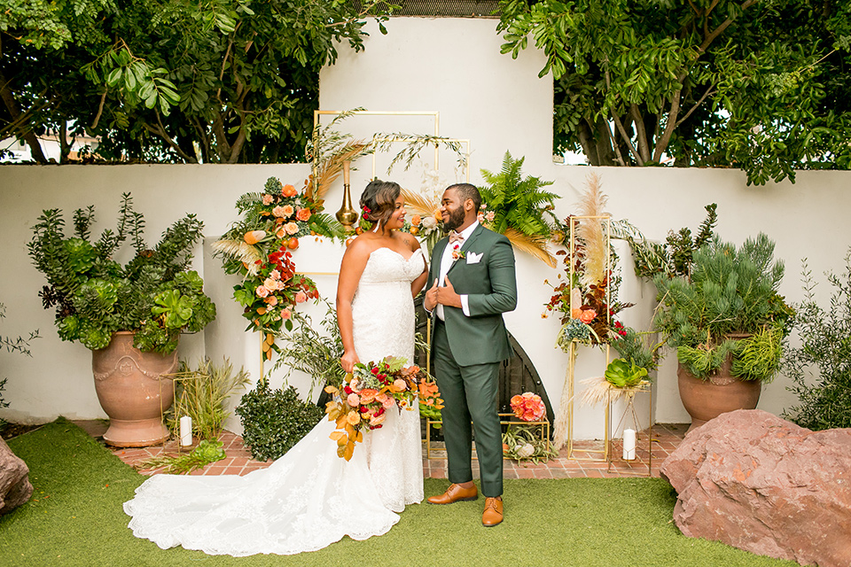  green and yellow casino san clemente wedding with the groom in a green suit – couple at ceremony spot