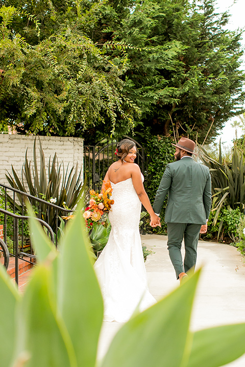  green and yellow casino san clemente wedding with the groom in a green suit - couple by the greenery 