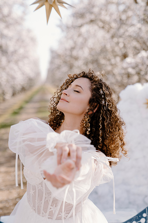  celestial cherry blossom wedding with the groom in a light blue coat and grey pants - bride