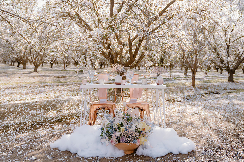  celestial cherry blossom wedding with the groom in a light blue coat and grey pants –sweetheart tables