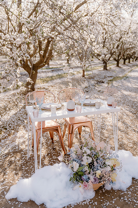  celestial cherry blossom wedding with the groom in a light blue coat and grey pants – reception tables 