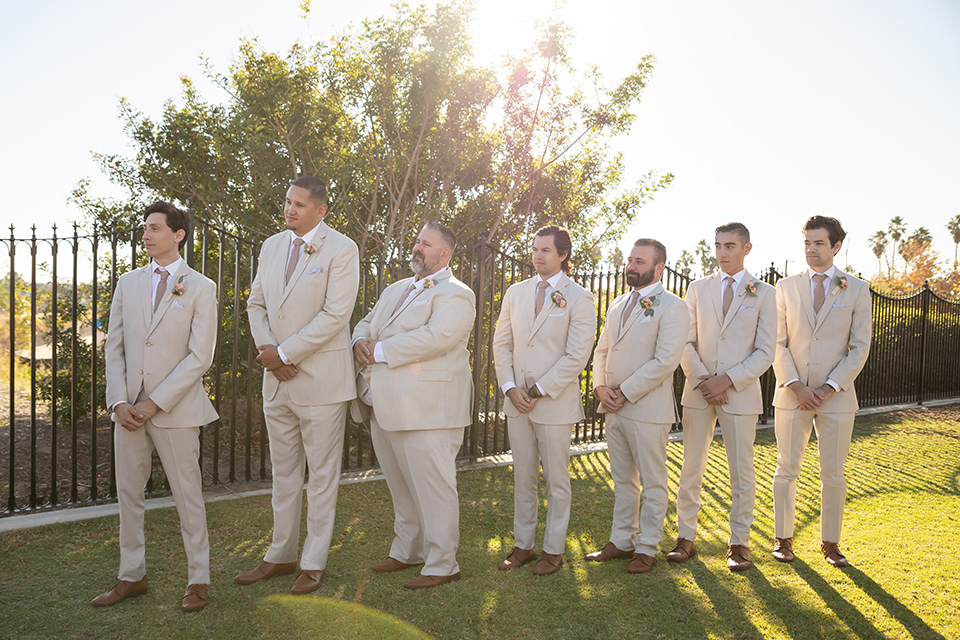  a groovy barn wedding with a neutral color palette and beer - groomsmen at ceremony 