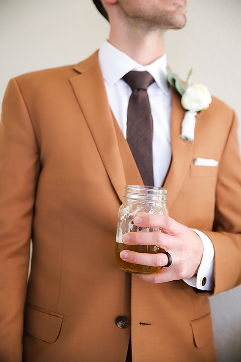  a groovy barn wedding with a neutral color palette and beer - groom 